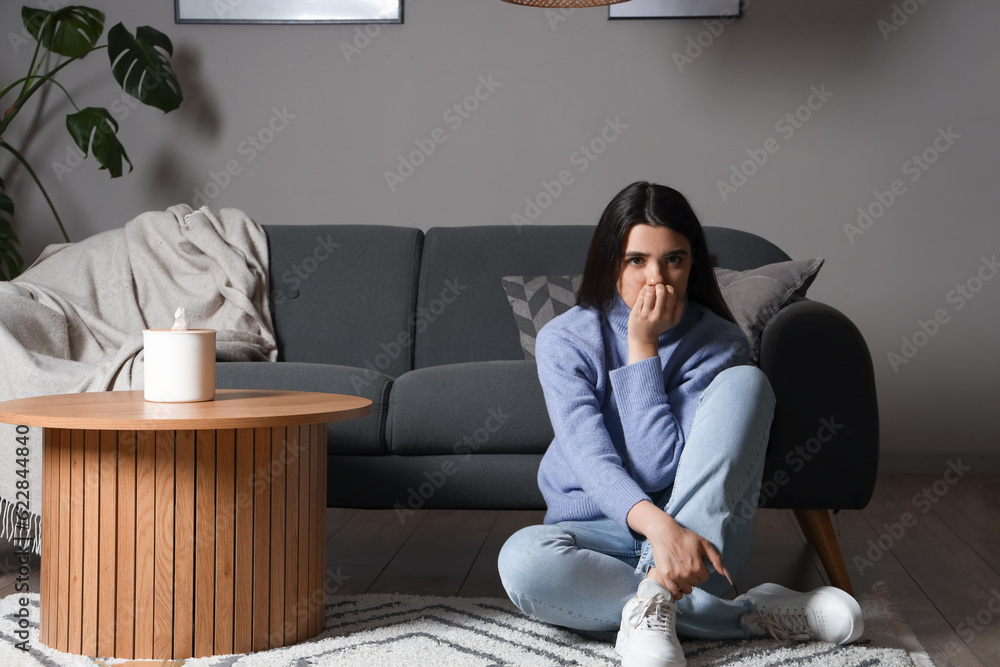 Young woman having panic attack at home