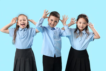 Poster - Funny little schoolchildren on light blue background