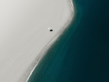 Aerial View Of An Umbrella On A White Beach, Sicily, Italy.