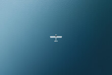 Aerial View Of A Plane Flying Above The Water, Sicily, Italy.