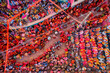 © AmazingAerialAgency - Barsana, India - 28 February 2023: Aerial view of people celebrating the holy colour festival in the street in Barsana, Uttar Pradesh, India.
