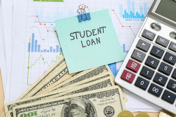 Wall Mural - Sticky note with text STUDENT LOAN, dollar banknotes and calculator on charts, closeup