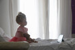 © triocean - Child sitting on bed watching cartoons on digital tablet