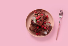 Plate With Pieces Of Raspberry Chocolate Brownie On Pink Background