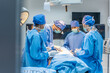 © Kawee - Professional doctors performing surgical operation in operating room.
