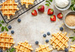 Freshly baked waffles with strawberries and blueberries