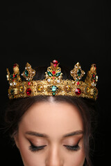 Wall Mural - Beautiful young woman wearing luxurious crown on black background, closeup