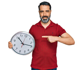 Sticker - Middle aged man with beard holding big clock smiling happy pointing with hand and finger