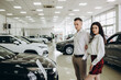 © Roman - Young couple buying a car in dealership