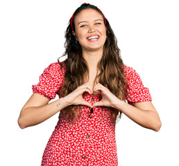 Sticker - Young hispanic girl doing heart symbol with hands smiling and laughing hard out loud because funny crazy joke.