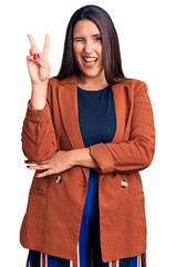 Sticker - Young beautiful brunette woman wearing elegant clothes smiling with happy face winking at the camera doing victory sign. number two.