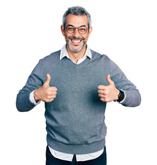 Sticker - Middle age hispanic with grey hair wearing glasses success sign doing positive gesture with hand, thumbs up smiling and happy. cheerful expression and winner gesture.