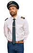 © Krakenimages.com - Handsome man with beard wearing airplane pilot uniform depressed and worry for distress, crying angry and afraid. sad expression.