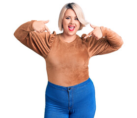 Wall Mural - Young blonde plus size woman wearing casual sweater looking confident with smile on face, pointing oneself with fingers proud and happy.