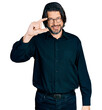 © Krakenimages.com - Middle age caucasian man wearing casual clothes and glasses smiling and confident gesturing with hand doing small size sign with fingers looking and the camera. measure concept.