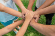 © Marina Demidiuk - Joined hands as a team. Business teamwork. Close up group of multiracial friends meeting join hands together. Diversity people. Partnership volunteer community. Diverse multiethnic Partners. Top View