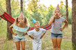 © Inna Vlasova - birthday, childhood and celebration concept - happy kids blowing party horns and having fun in summer outdoors