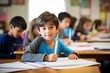 © Dragan - Generative AI, Primary Elementary School, the boy is sitting in the classroom holding a pencil