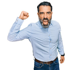 Sticker - Middle aged man with beard wearing business shirt angry and mad raising fist frustrated and furious while shouting with anger. rage and aggressive concept.