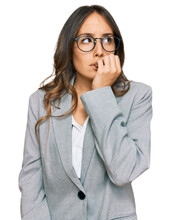 Young Brunette Woman Wearing Business Clothes Looking Stressed And Nervous With Hands On Mouth Biting Nails. Anxiety Problem.