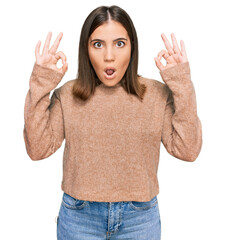 Poster - Young beautiful woman wearing casual clothes looking surprised and shocked doing ok approval symbol with fingers. crazy expression