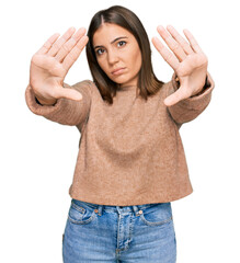 Sticker - Young beautiful woman wearing casual clothes doing frame using hands palms and fingers, camera perspective