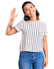 Sticker - Young woman wearing casual clothes waiving saying hello happy and smiling, friendly welcome gesture