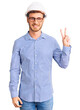 © Krakenimages.com - Handsome young man with bear wearing architect hardhat smiling with happy face winking at the camera doing victory sign. number two.