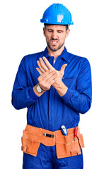 Poster - Young handsome man wearing worker uniform and hardhat touching painful neck, sore throat for flu, clod and infection