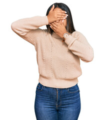 Poster - Young latin girl wearing wool winter sweater covering eyes and mouth with hands, surprised and shocked. hiding emotion