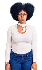 Canvas Print - Young african american girl wearing casual clothes and glasses depressed and worry for distress, crying angry and afraid. sad expression.