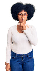 Poster - Young african american girl wearing casual clothes and glasses asking to be quiet with finger on lips. silence and secret concept.