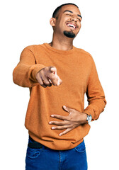 Wall Mural - Young african american man wearing casual clothes laughing at you, pointing finger to the camera with hand over body, shame expression