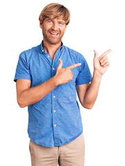 Sticker - Handsome caucasian man with beard wearing casual clothes smiling and looking at the camera pointing with two hands and fingers to the side.