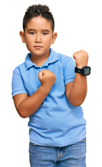 Poster - Little boy hispanic kid wearing casual clothes ready to fight with fist defense gesture, angry and upset face, afraid of problem