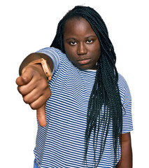 Canvas Print - Young black woman with braids wearing casual clothes looking unhappy and angry showing rejection and negative with thumbs down gesture. bad expression.