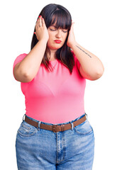 Poster - Young plus size woman wearing casual clothes suffering from headache desperate and stressed because pain and migraine. hands on head.