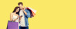 © vgstudio - Love, holiday sales, shop, retail, consumer concept - happy couple with shopping bags, looking at mobile phone, standing close to each other. Studio portrait of man and woman, isolated over yellow.