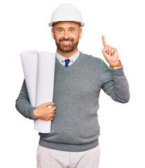 Poster - Handsome middle age man holding paper blueprints surprised with an idea or question pointing finger with happy face, number one