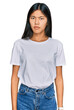 © Krakenimages.com - Beautiful young asian woman wearing casual white t shirt skeptic and nervous, frowning upset because of problem. negative person.