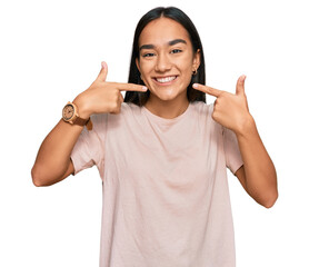 Poster - Young asian woman wearing casual clothes smiling cheerful showing and pointing with fingers teeth and mouth. dental health concept.