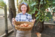 © Robert Kneschke - Female farmer carrying wicker basket with brown eggs