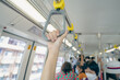 Woman hand firm grip safety handrail in elevated monorail train. Mass transit system in modern city. Inside of electric train. Tourist travel by city sky train. Public transportation. Urban transport.