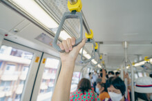 Woman Hand Firm Grip Safety Handrail In Elevated Monorail Train. Mass Transit System In Modern City. Inside Of Electric Train. Tourist Travel By City Sky Train. Public Transportation. Urban Transport.