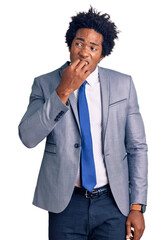 Poster - Handsome african american man with afro hair wearing business jacket looking stressed and nervous with hands on mouth biting nails. anxiety problem.