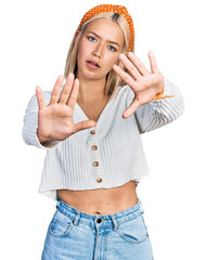 Poster - Beautiful young blonde woman wearing casual white sweater doing frame using hands palms and fingers, camera perspective