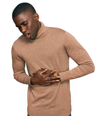 Young african american man wearing casual winter sweater with hand on stomach because nausea, painful disease feeling unwell. ache concept.