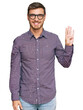 © Krakenimages.com - Handsome caucasian man wearing casual clothes and glasses showing and pointing up with fingers number four while smiling confident and happy.