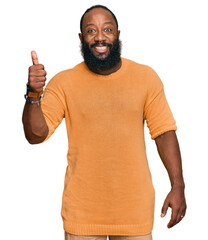 Poster - Young african american man wearing casual clothes smiling happy and positive, thumb up doing excellent and approval sign