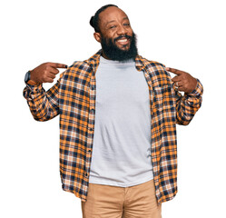 Poster - Young african american man wearing casual clothes looking confident with smile on face, pointing oneself with fingers proud and happy.